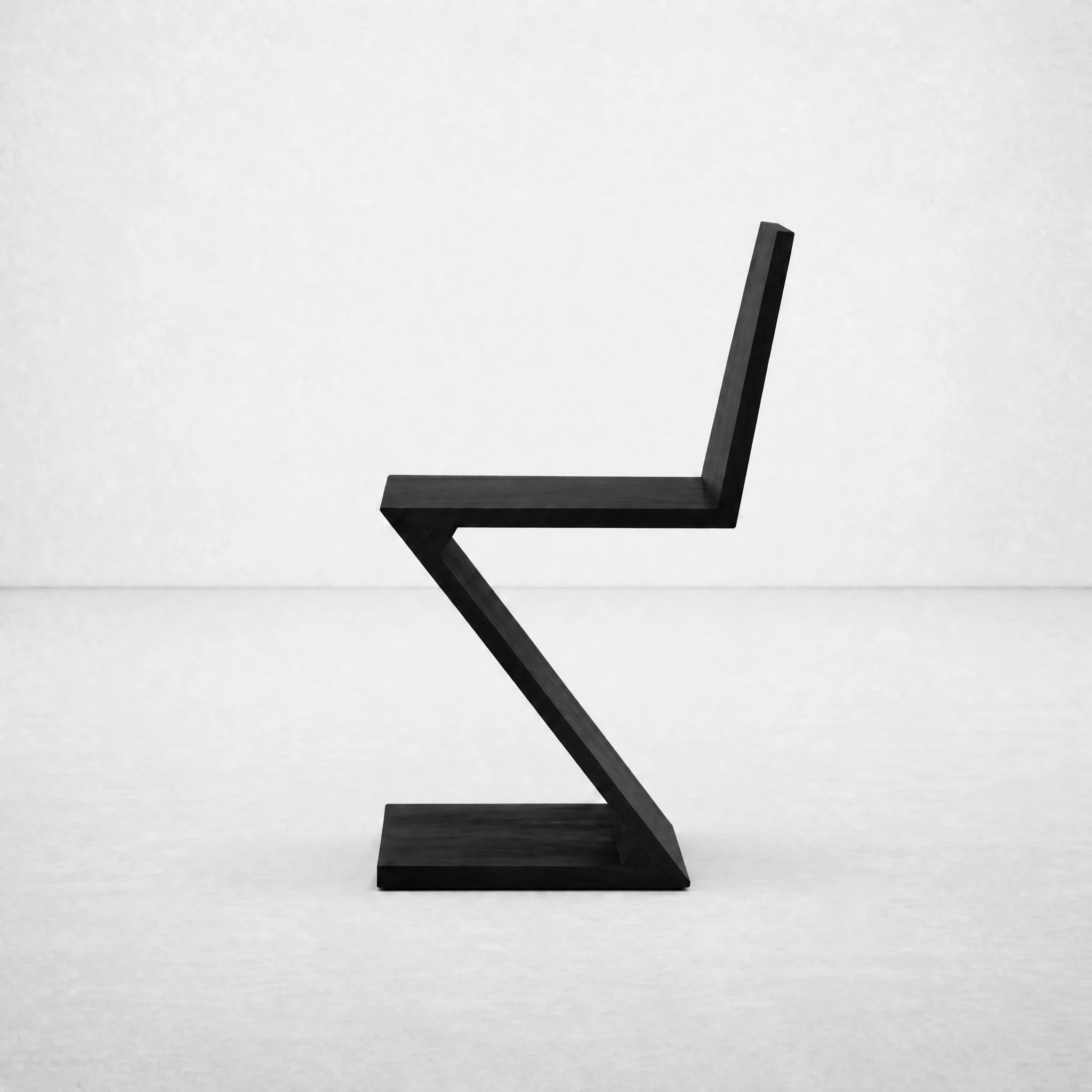 Black Zig Zag Chair angled view showing the zig-zagging plane silhouette