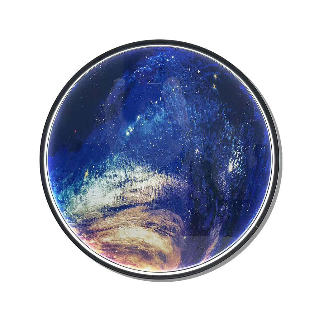A stunning circular glass orb featuring a vibrant swirling galaxy with deep blue, gold, and white stars, framed in a silver rim.