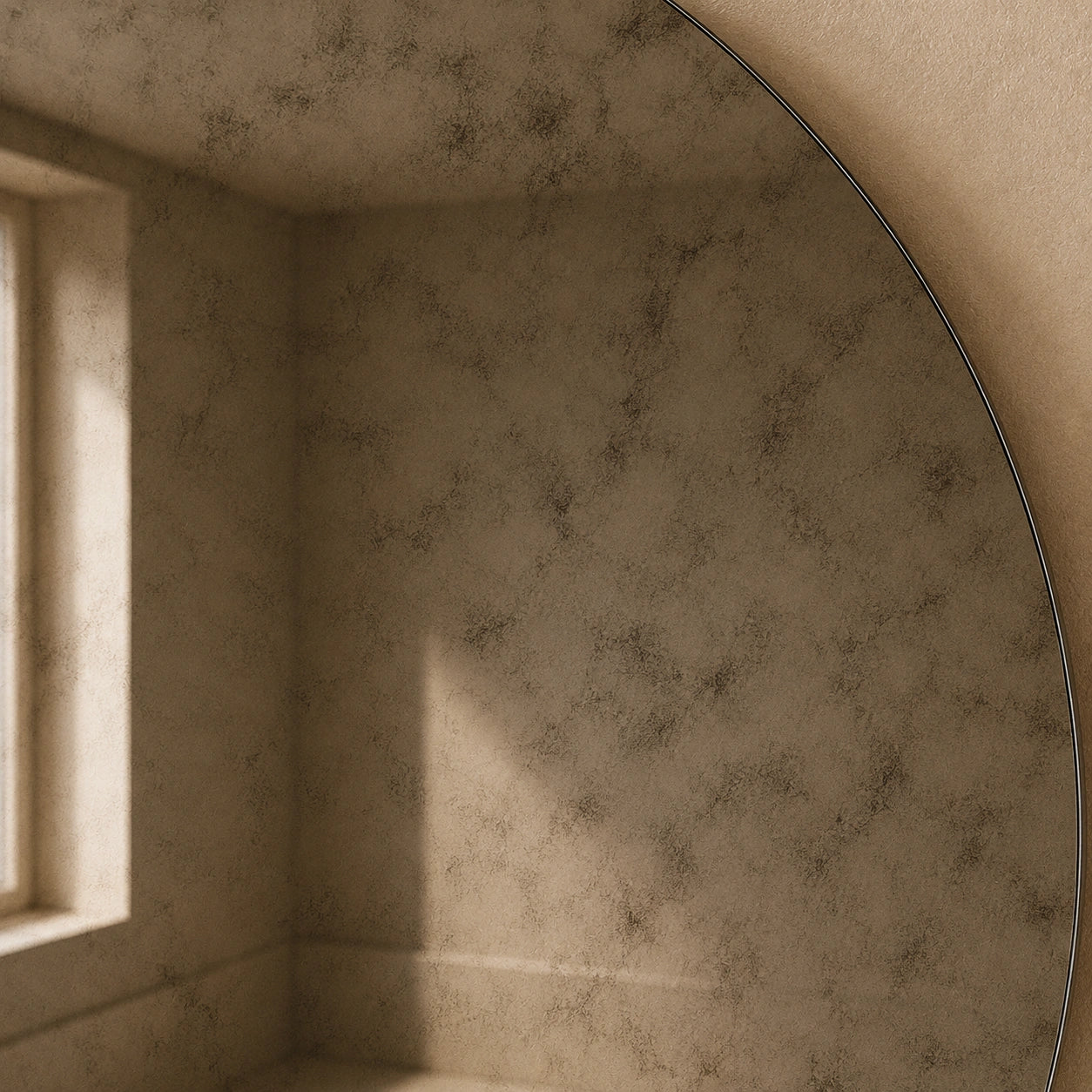 Frameless edge detail of a smoked antiqued round mirror surface