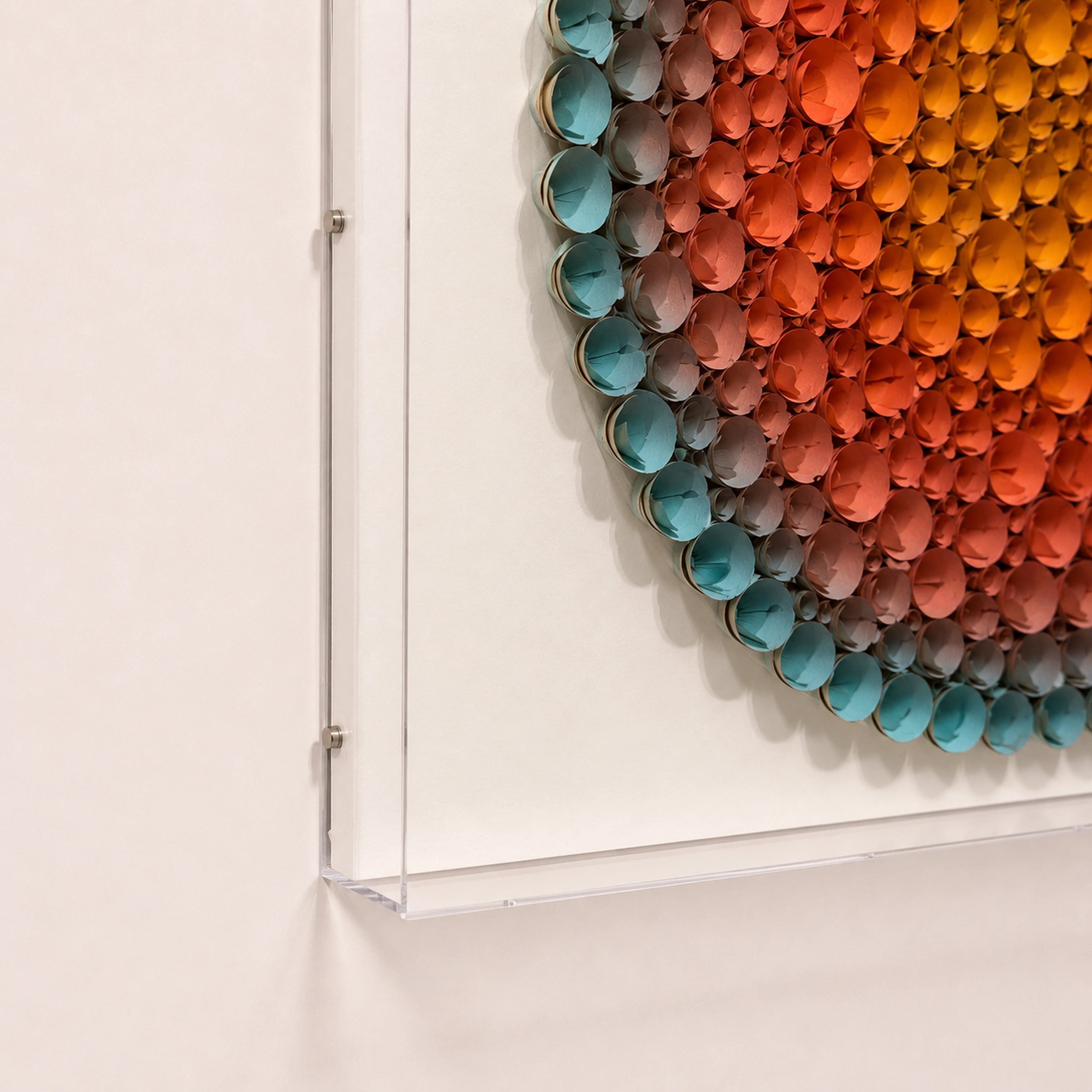 Coronal Bloom — orange and blue round paper wall art in a clear acrylic shadow box — acrylic box edge detail