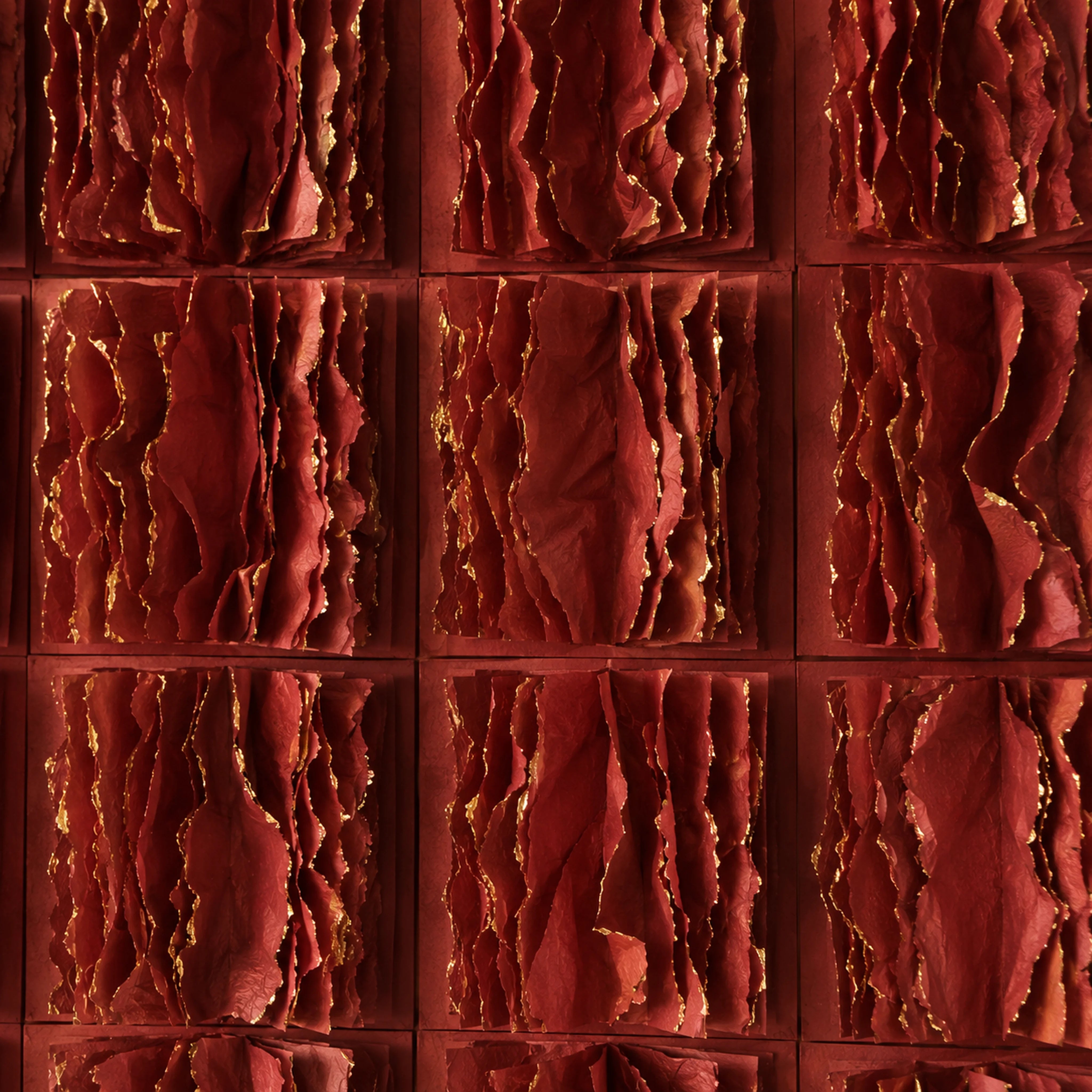 Close detail of layered paper tiles with gold-leaf edges in Garnet Ombré wall art