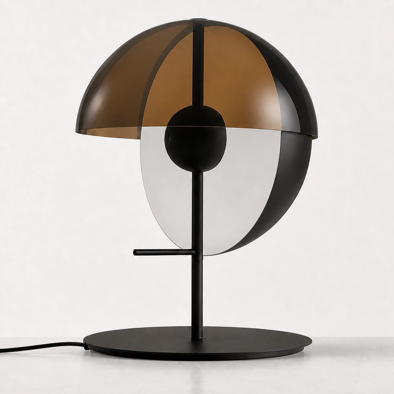 Orryn smoked amber glass table lamp with black circular base — daytime