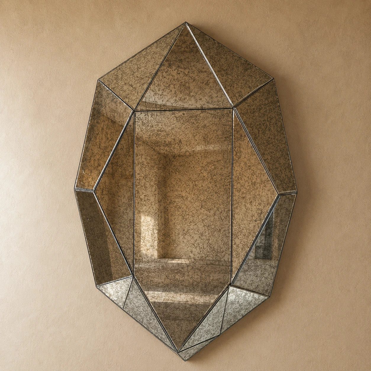 Faceted antiqued smoke wall mirror — irregular gemstone-cut silver-grey glass, straight-on hero