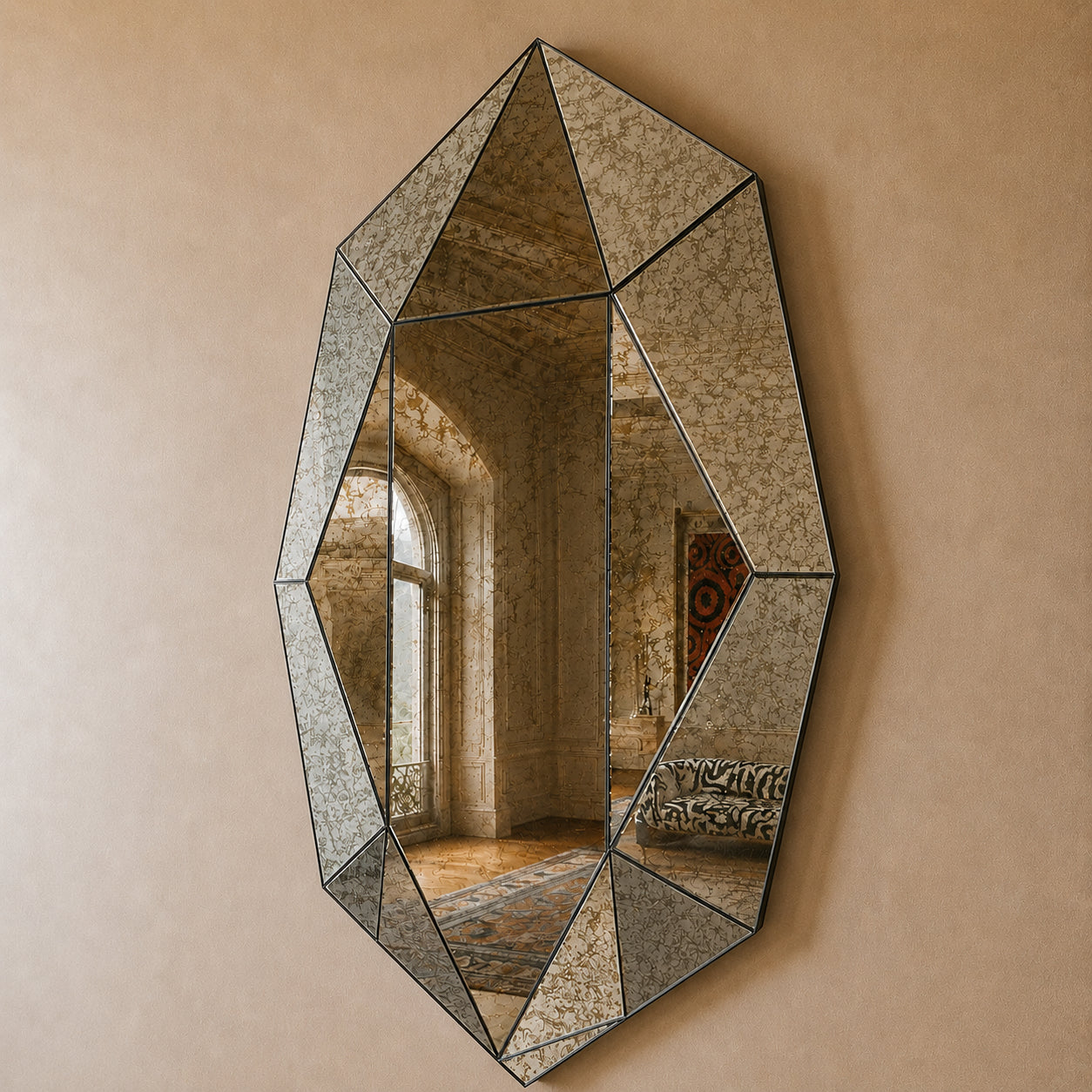 Antiqued smoke faceted gemstone mirror on a warm plaster wall in a grand antiqued interior