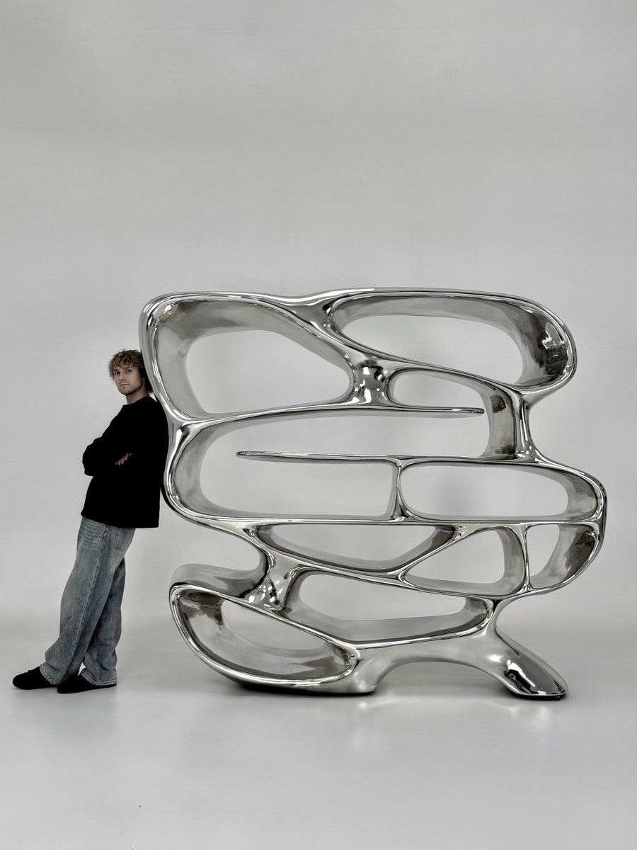 Cole with the Chrome Mirage Bookshelf in the studio