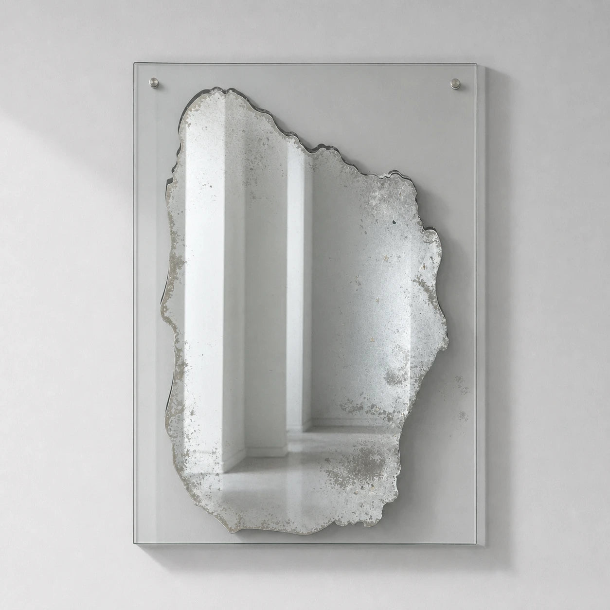 Distressed silver rectangular wall mirror on clear glass, straight-on view