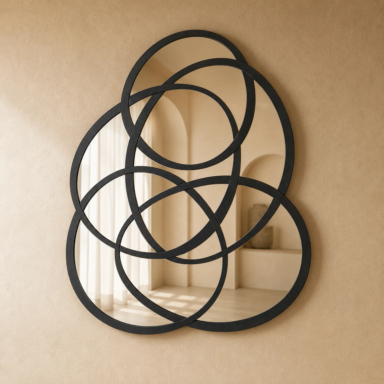 Rings of Infinity Wall Mirror in black on a warm plaster wall