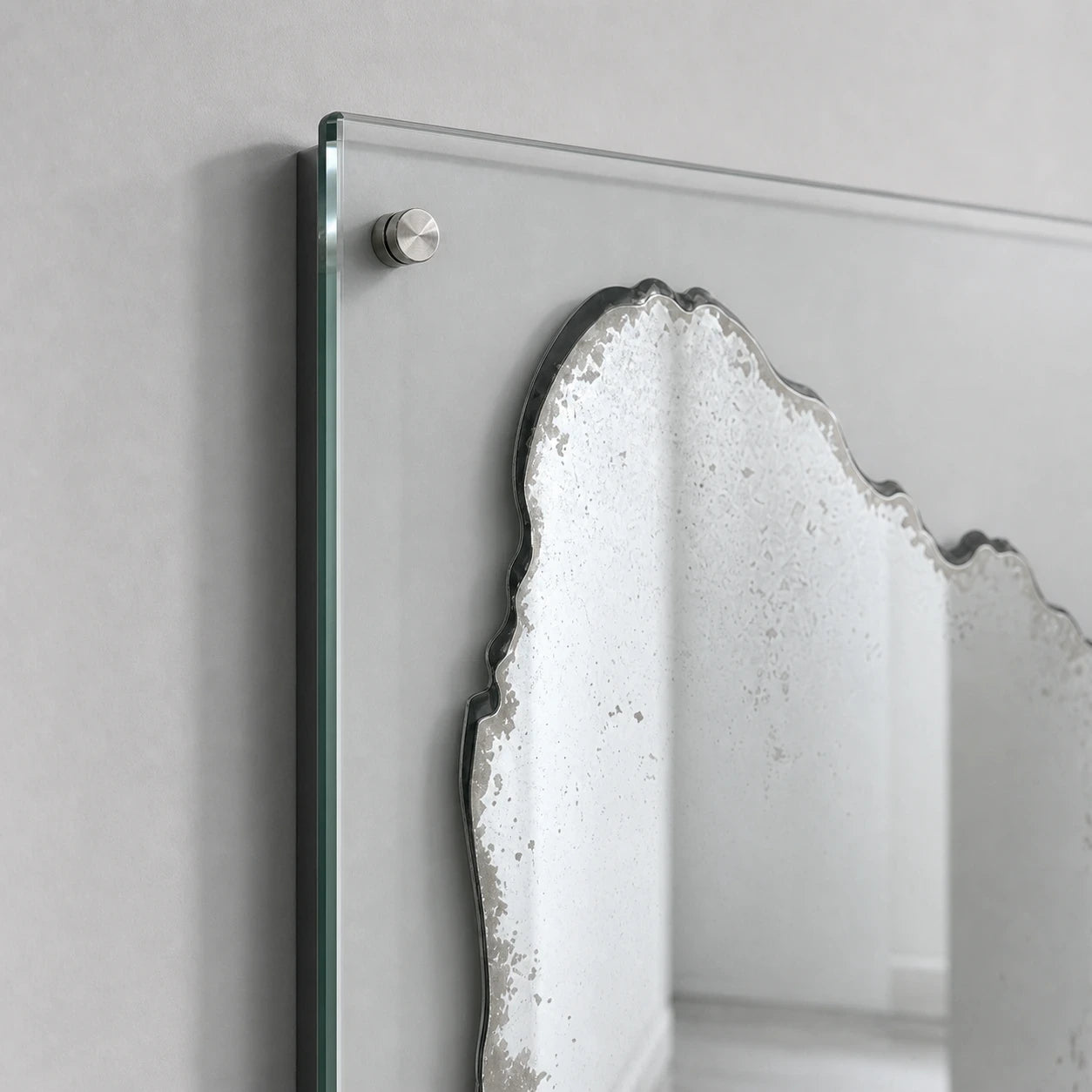 Distressed silver mirror patina and clear glass mounting detail