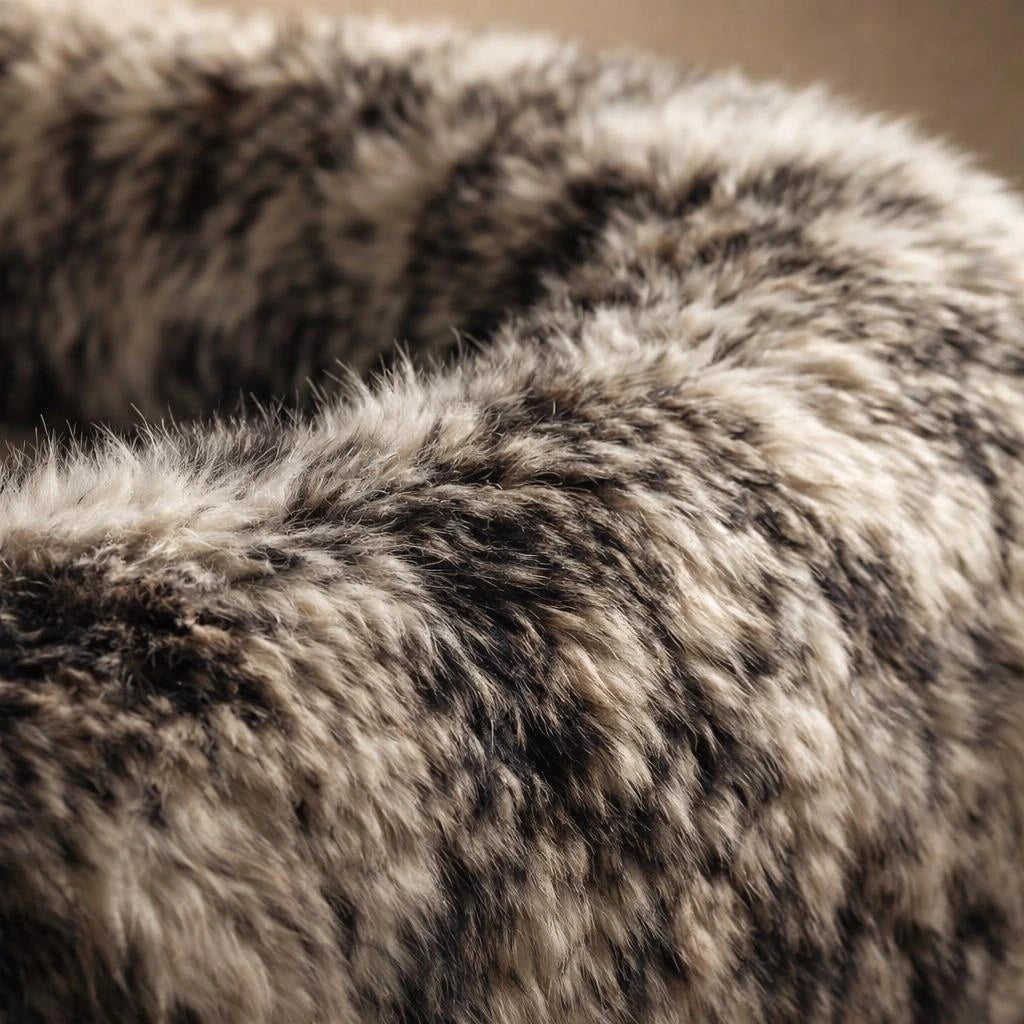 Black and white shaggy faux fur upholstery texture detail, pod sofa
