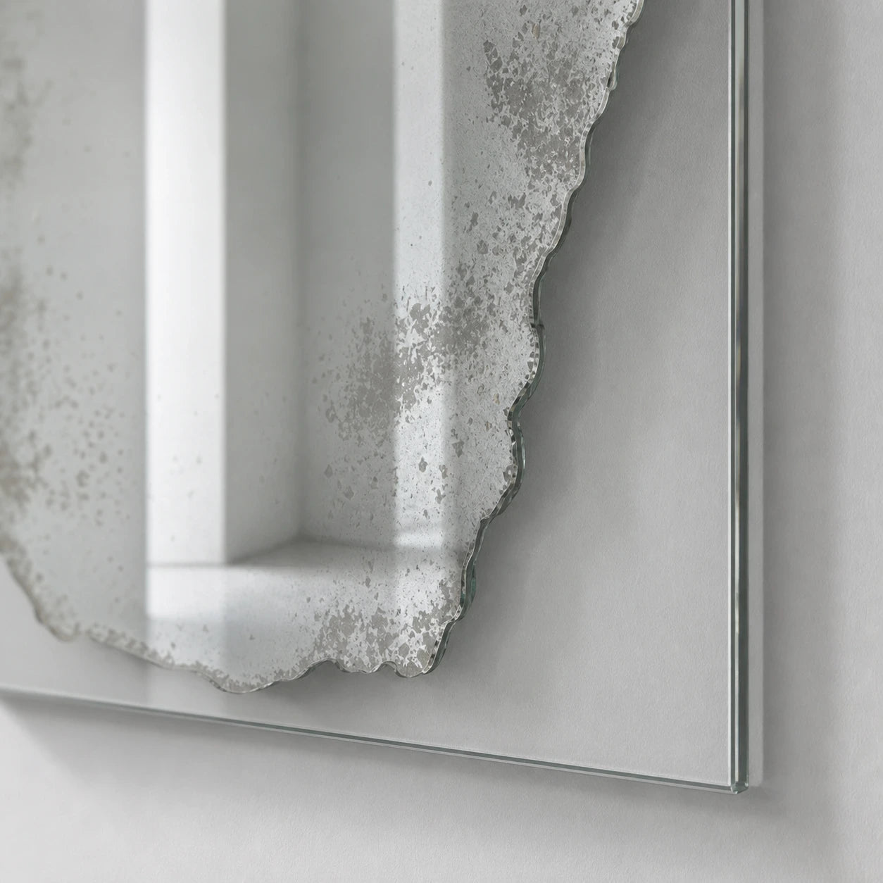 Distressed mercury silver mirror finish on clear glass, close detail