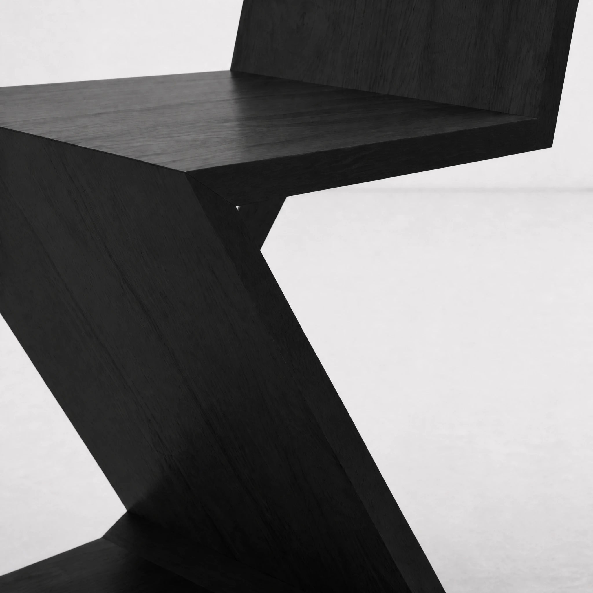Black Zig Zag Chair three-quarter view on light background