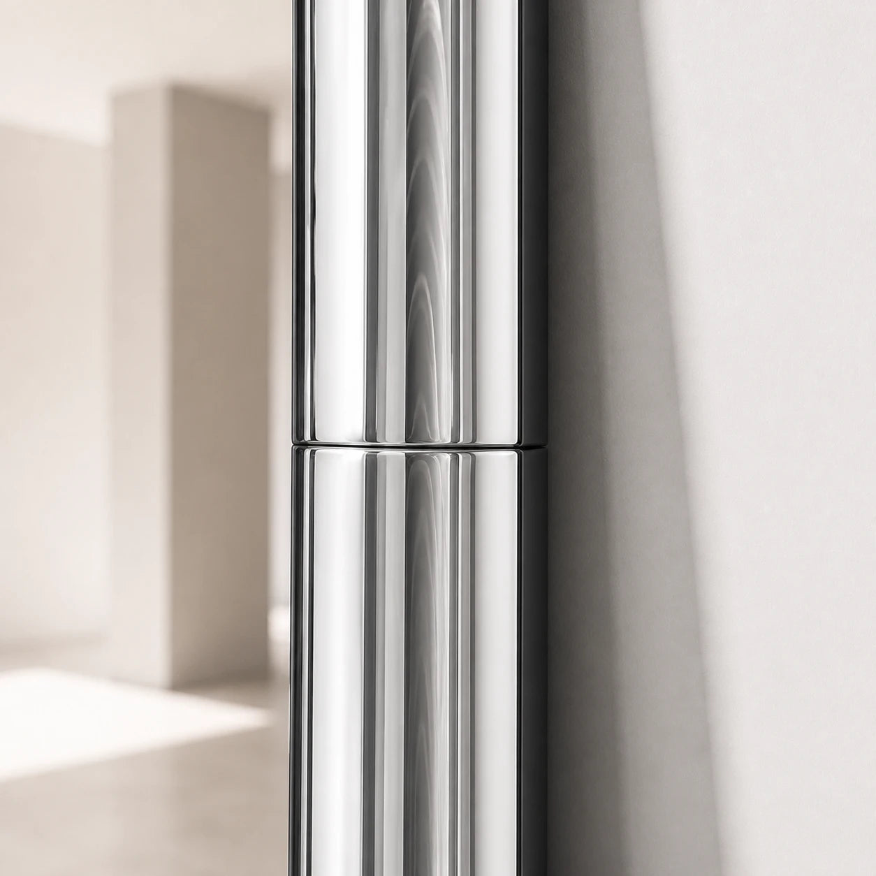 Close-up of the Atrium Floor Mirror frame joint and polished chrome finish