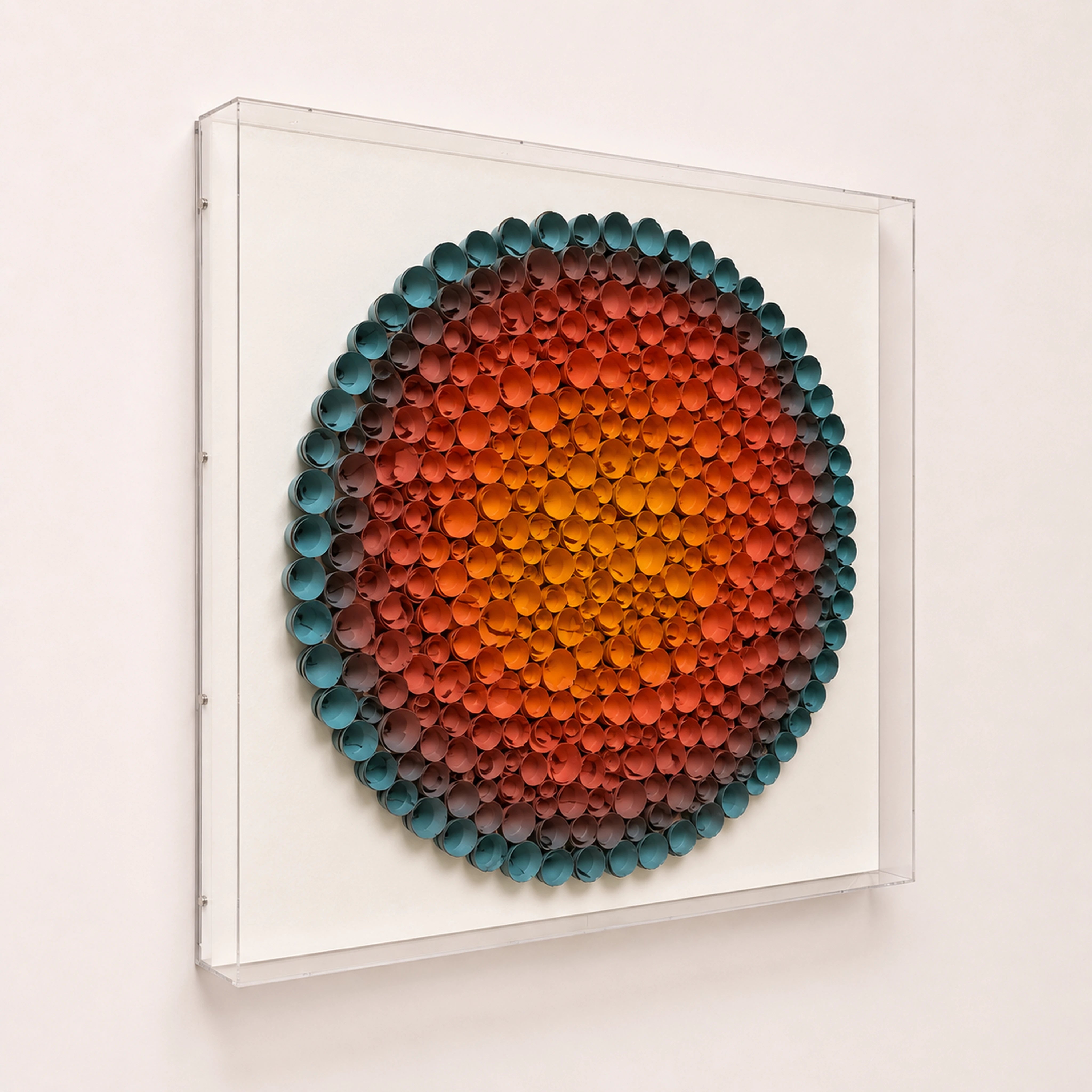 Coronal Bloom — orange and blue round paper wall art in a clear acrylic shadow box — three-quarter angle showing acrylic box depth
