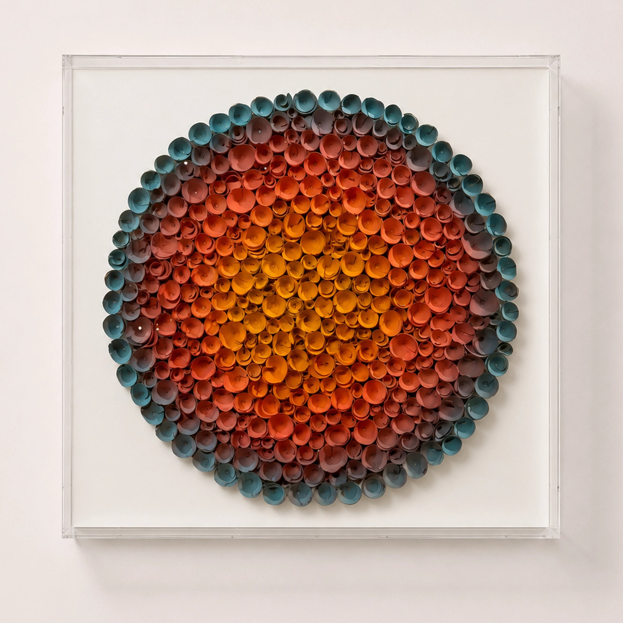 Coronal Bloom — orange and blue round paper wall art in a clear acrylic shadow box — hero on white wall