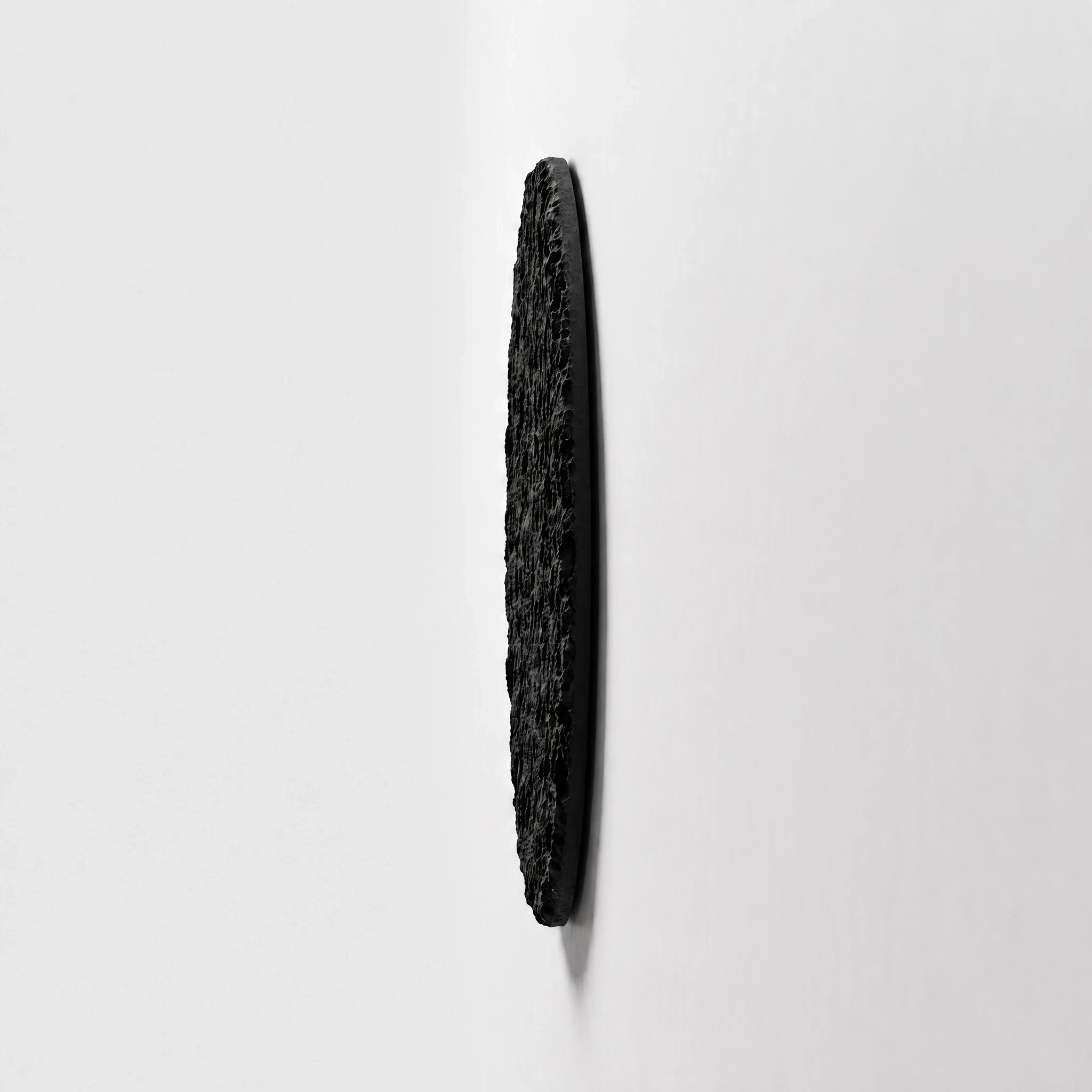 Side profile of Erosion Obsidian Void showing its wall-mounted panel depth