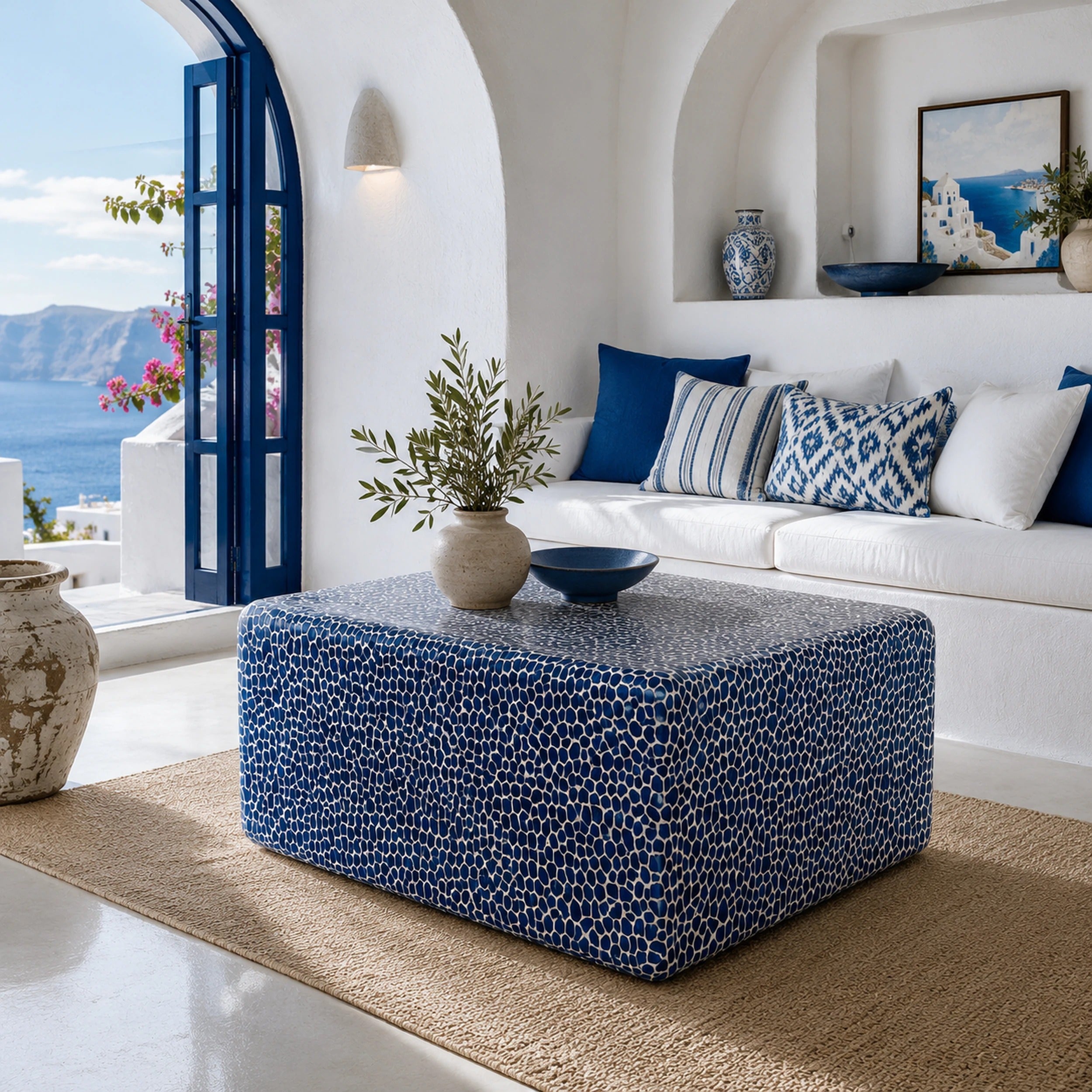 Blue and white mosaic coffee table styled in a white Mediterranean room with sea view