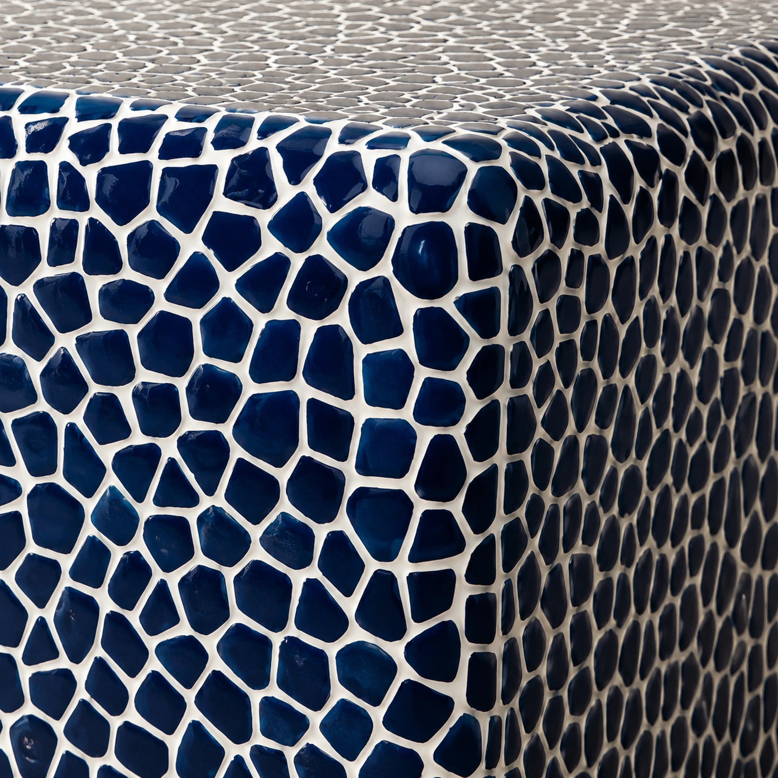 Close-up of the glossy navy-blue and white hand-laid ceramic mosaic tiles