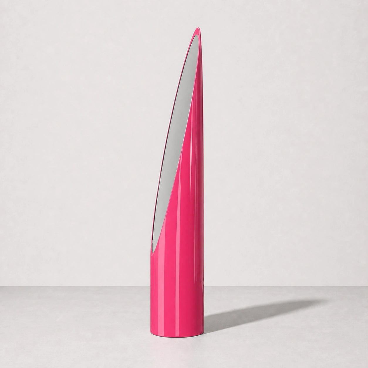 Pink sculptural Lipstick floor mirror, right three-quarter studio view