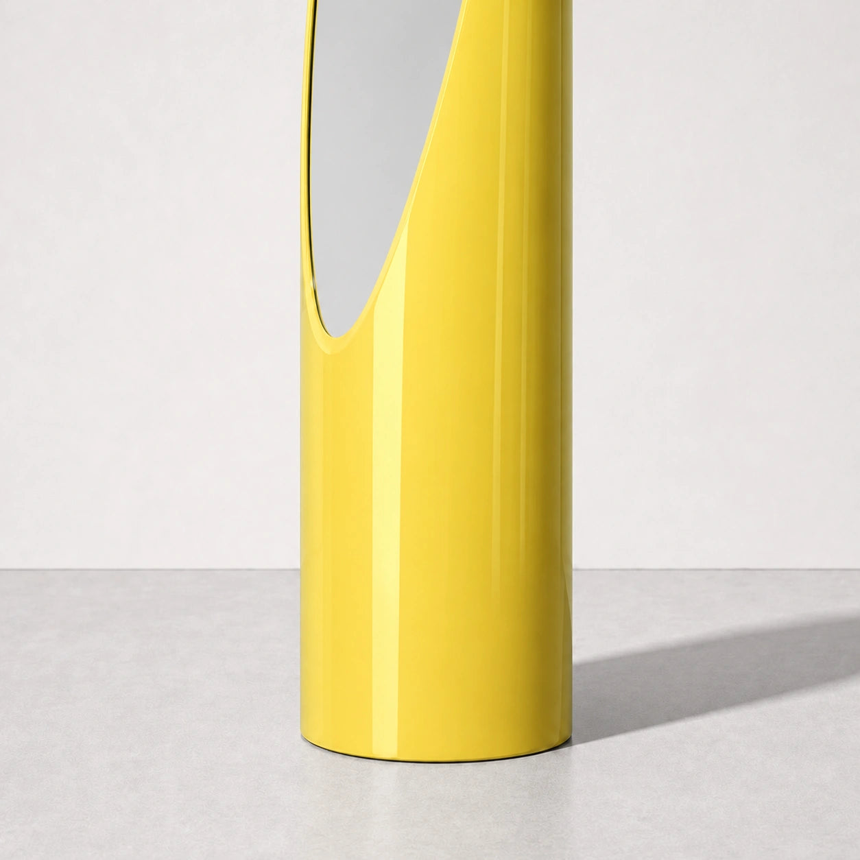 High-gloss yellow Lipstick mirror curved base and finish detail